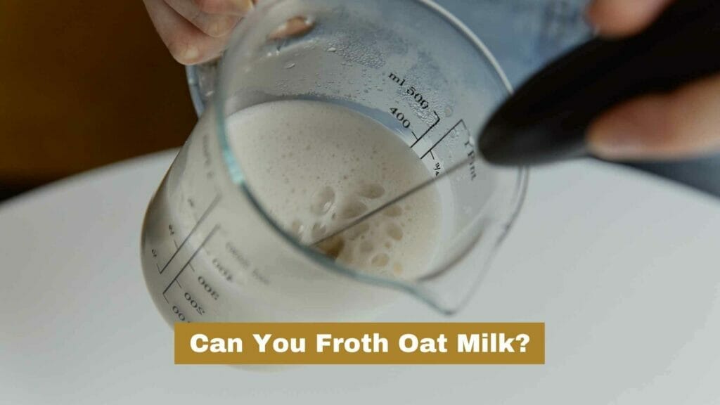 Photo of oat milk being frothed with a frothing wand. Can You Froth Oat Milk?