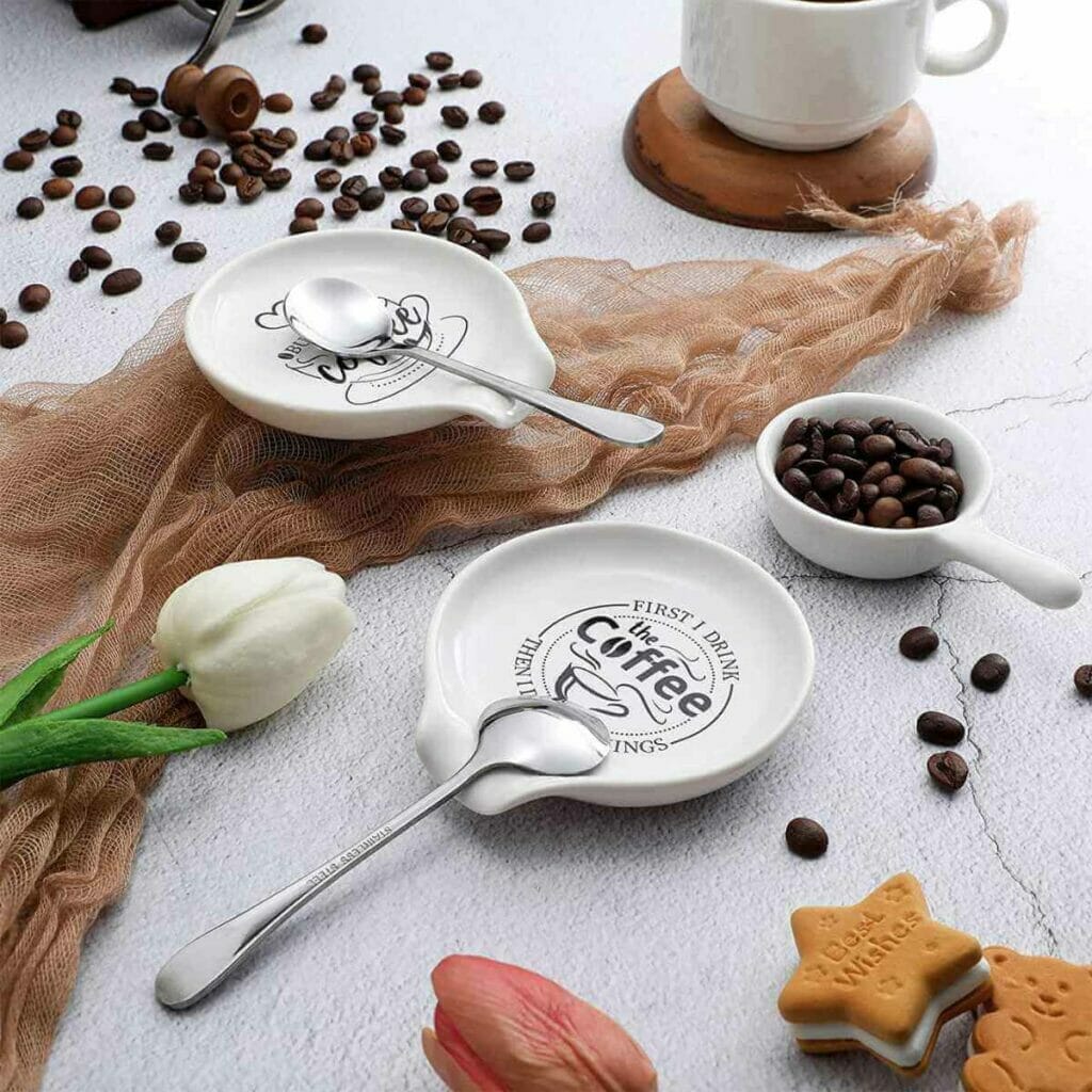 Photo of a coffee spoon holder with coffee beans around.