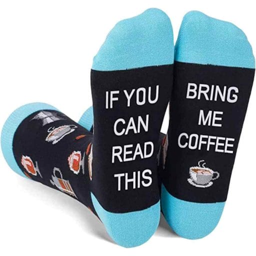 Photo of a blue pair of funny coffee socks with the frase "If you can read this bring me coffee" written on the bottom and a design of a coffee mug.