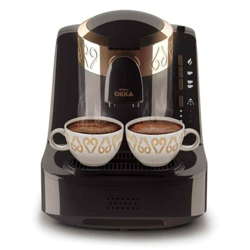 Photo of a black with gold accents Arzum Okka Electric Coffee Machine with two finished to pour cups of coffee.