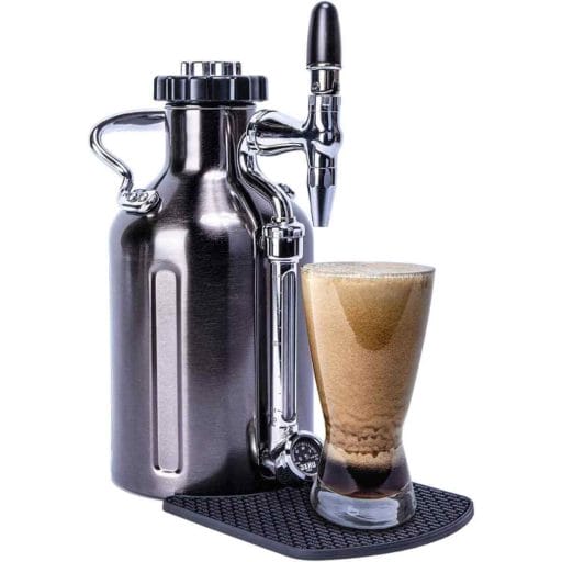 Photo of a silver stainless steel GrowlerWerks uKeg Cold Brew Coffee Maker with a glass of nitro cold brew coffee on its base.