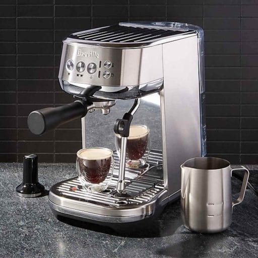 Photo of a Breville Bambino Plus making a cup of coffee.