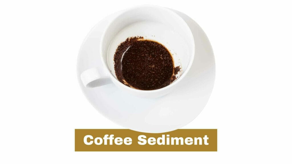 Photo of a white cup of coffee with coffee sediment in the bottom.